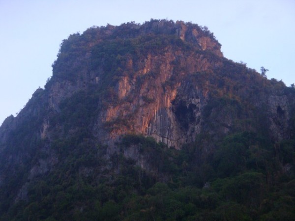 Suddenly, the rock face around the cave entrance started to turn a reddish colour.