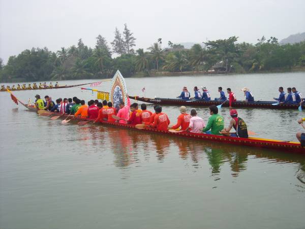 Dragon boats with a large picture onboard.