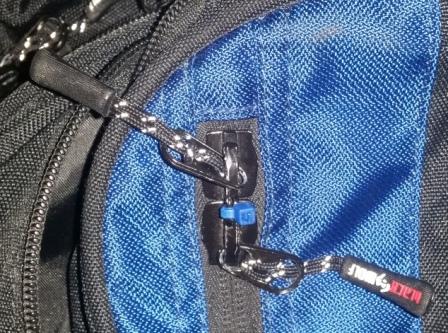 blue cable tie threaded through zip pulls