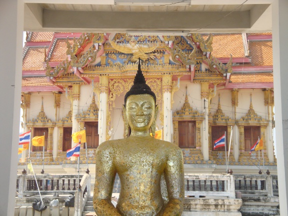 Buddha image and temple beyond.